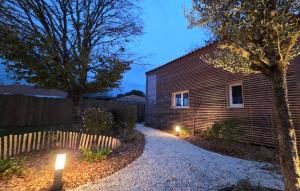 a house with two lights on the side of it at Cottage Atypique in Saint-Laurent-de-la-Prée +2 photos
