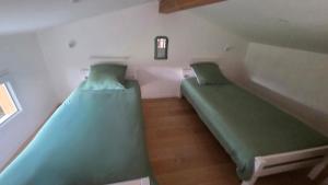 a room with two bunk beds in a house at Cottage Atypique in Saint-Laurent-de-la-Prée