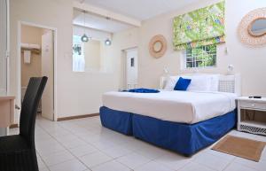 a bedroom with a large bed and a chair at Melbourne Inn in Christ Church +80 photos