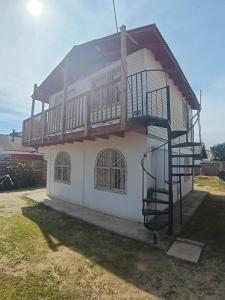 a house with a staircase in front of it at Cabaña El Quisco 2do piso con estacionamiento in El Quisco