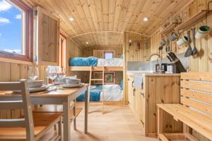 a kitchen and dining area of a tiny house at Starry Nights Escape - Hot Tub & Sauna in Yarpole