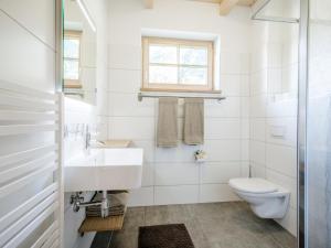 a white bathroom with a sink and a toilet at Sperlingnest in Donnersbachwald +68 photos