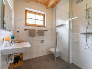 a bathroom with a shower and a sink and a toilet at Auerhahn in Donnersbachwald +50 photos