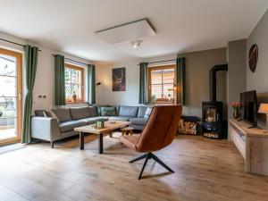 a living room with a couch and a table at Auerhahn in Donnersbachwald