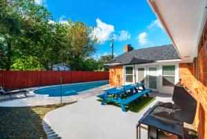 un patio trasero con una mesa de picnic y una valla en Amazing 4BR 2BA Winter Home with Pool & Game-Movie Room, en Texas City