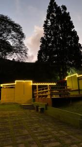 a group of benches in a park with lights at Bike Ville Fojo in Campos do Jordão