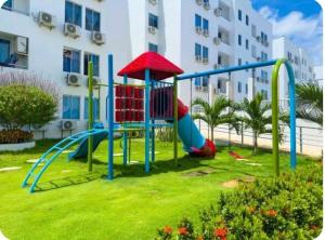 a playground in front of a apartment building at Acogedor apto en Coveñas 301 in Coveñas