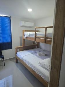 a bedroom with two bunk beds in a room at Acogedor apto en Coveñas 301 in Coveñas +22 photos