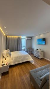 Ένα ή περισσότερα κρεβάτια σε δωμάτιο στο Apt 711 - Elegância com vista parcial do mar