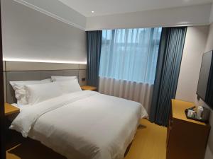 Ένα ή περισσότερα κρεβάτια σε δωμάτιο στο Hangzhou Wulinmen Bernard Hotel Gongshu District Branch +19 φωτογραφίες