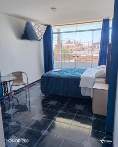 Postel nebo postele na pokoji v ubytování Hotel El Arizal Paracas