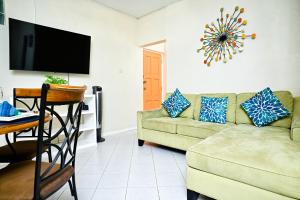 a living room with a couch and a table at Melbourne Inn in Christ Church