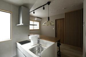 a kitchen with a sink and a counter at 晴レ吉 in Fukuoka