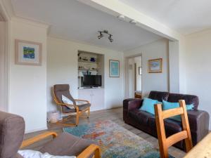 a living room with a couch and a chair at Estuary House Flat 3 in Salcombe