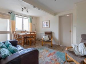 a living room with a couch and a table at Estuary House Flat 3 in Salcombe +9 photos