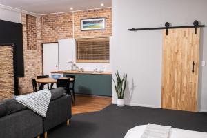 a living room with a couch and a kitchen at Mirambeena Retreat in Toowoomba