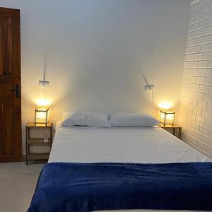 En eller flere senge i et værelse på Pousada Encantos do Rosa