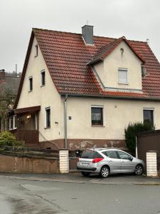 a car parked in front of a house at Corner Haus RM1 in Schnaittach