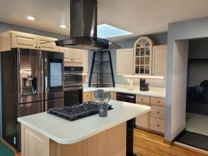 a kitchen with a white counter top and a black refrigerator at Perrysburg On The River in Perrysburg