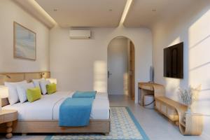 a bedroom with a large bed and a television at Noska Hotel Sunset Town Sea View & Fireworks in Phú Quốc