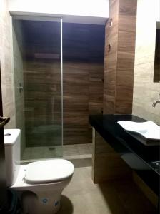 a bathroom with a toilet and a glass shower at Hotel Sky - Tarija in Tarija