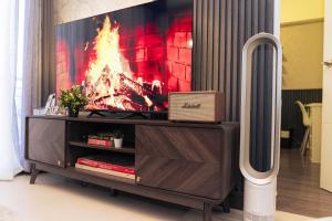 un centro di intrattenimento con un fuoco sullo schermo di Casa Celestine Staycation a Manila