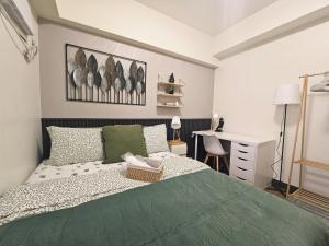 una camera con letto verde e scrivania di Casa Celestine Staycation a Manila Altre 105 foto