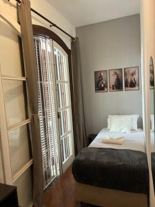 a bedroom with a bed and a large window at Morumbi Mansão 278 in Sao Paulo