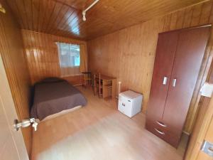 康塞普西翁Habitación individual para hombres `的一间带床和书桌的小卧室