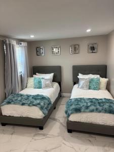 Dos camas una al lado de la otra en un dormitorio. en Peace and Tranquility awaits, en Miami Gardens