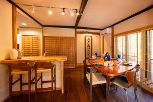 a dining room with a wooden table and chairs at Nagi GIVE 日光 in Nikko