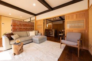 a living room with a couch and a chair at Nagi GIVE 日光 in Nikko