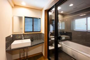 a bathroom with a sink and a bath tub at Nagi GIVE 日光 in Nikko +74 photos