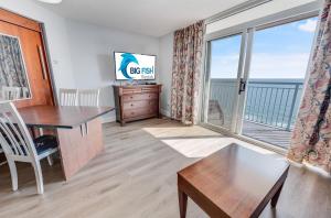 a room with a desk and a large window at Roxanne Towers Remodeled with Amazing Views,Pools! in Myrtle Beach