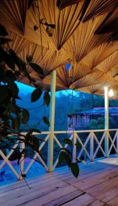 a wooden porch with a view of the ocean at Zen Garden Palace in Ella