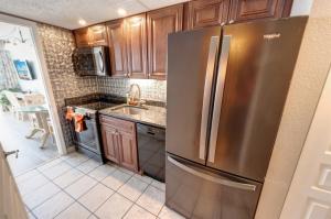 a kitchen with a stainless steel refrigerator at Condo near Barefoot Landing w beach access in Myrtle Beach