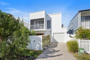 a white house with a white fence at Seabreeze in Kingscliff