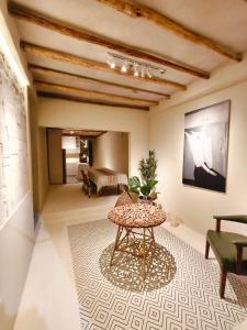 a living room with a table and a couch at Casa Rocka Boutique Isla Mujeres in Isla Mujeres