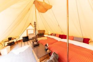 a room with two beds in a tent at ザランタン鹿沼 in Kanuma