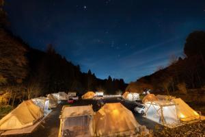 a group of tents in a field at night at ザランタン鹿沼 in Kanuma