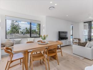 a living room with a table and chairs and a couch at Kai Residences in Cabarita Beach