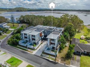 an aerial view of a house with a river in the background at Kai Residences in Cabarita Beach