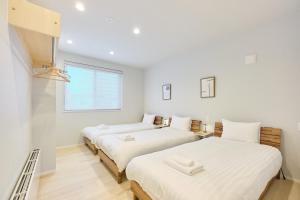 Postel nebo postele na pokoji v ubytování 星宿 Asahikawa Miyashita