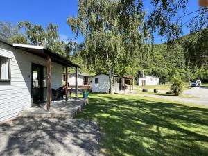 a dog sitting on the porch of a house at Parklands Marina Holiday Park in Picton