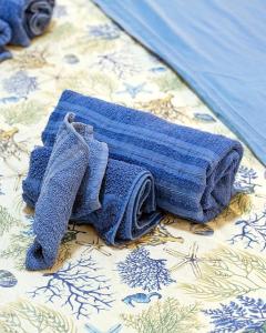 un paio di asciugamani seduti sopra un tavolo di La Perla di Marzamemi a Marzamemi Altre 120 foto