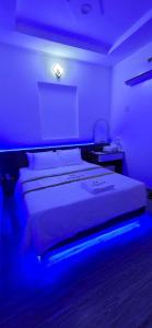 a bedroom with a bed with a blue light at Mina Motel 2 in Thuan An +13 photos