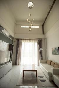 a living room with a couch and a table at Lazy shot in Ban San Ton Ko (1)