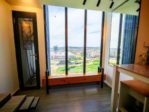 a room with a bench in front of a window at Lovina 12-19 Pollux Meisterstadt in Batam Center