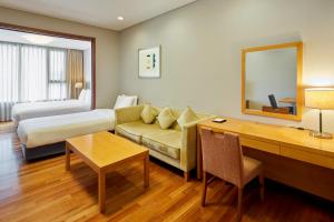 a hotel room with a couch and a bed at Somerset Palace Seoul in Seoul +44 photos