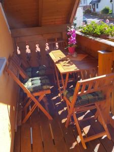 a deck with two chairs and a table and chairs at Ferienhaus am Radweg in Brotterode